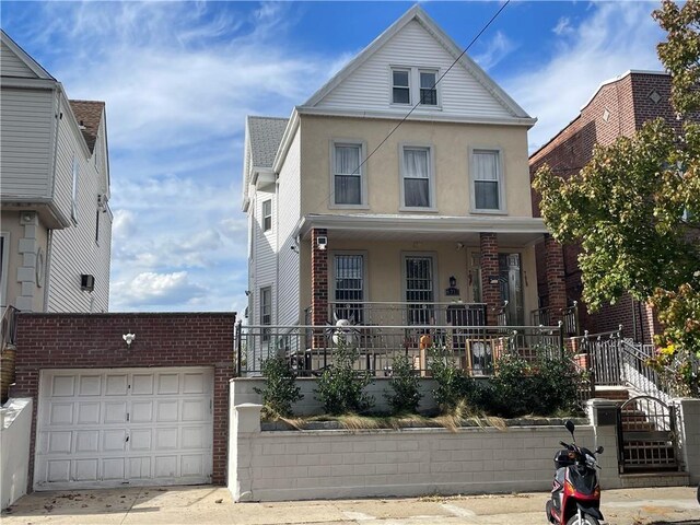 front of property featuring a porch and a garage