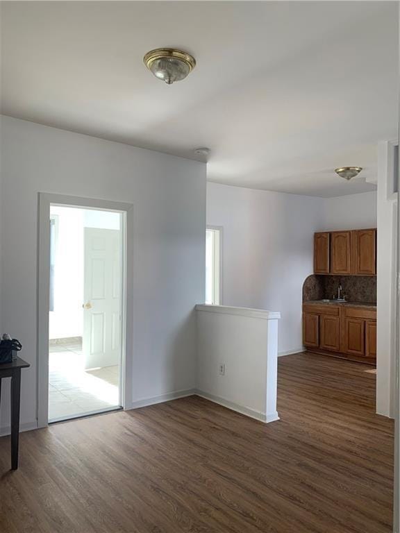 1738 79th St, Brooklyn, NY 11214 - unfurnished room featuring dark wood-style floors, a sink, and baseboards