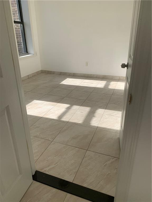 1738 79th St, Brooklyn, NY 11214 - empty room featuring light tile patterned flooring and baseboards