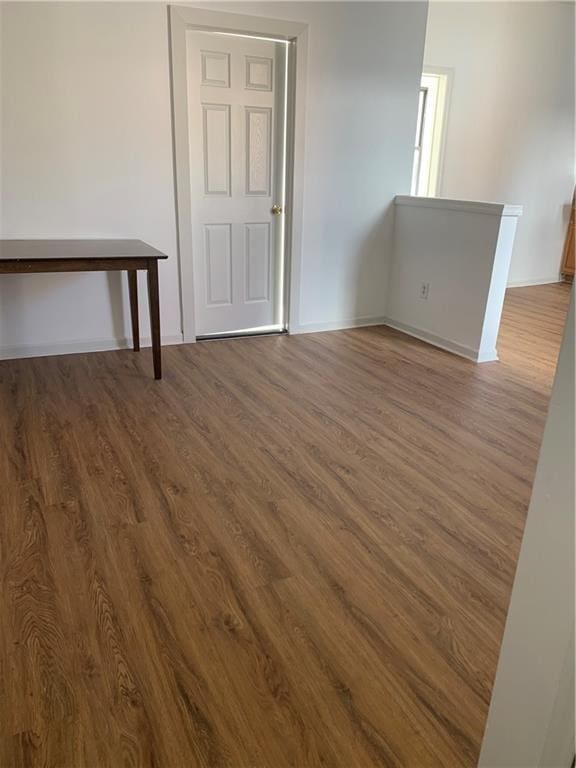 empty room with hardwood / wood-style flooring