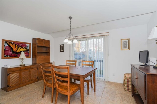 tiled dining area featuring a chandelier