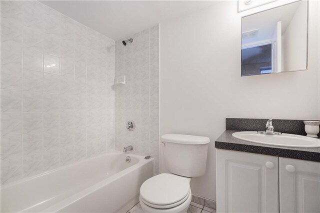 full bathroom with vanity, tile patterned floors, tiled shower / bath combo, and toilet