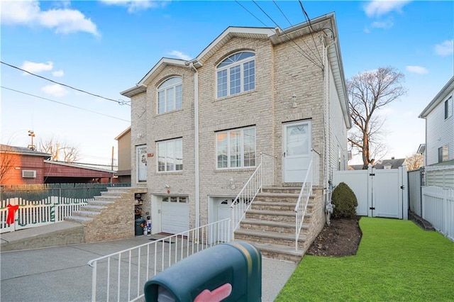 view of front of property with a garage and a front lawn