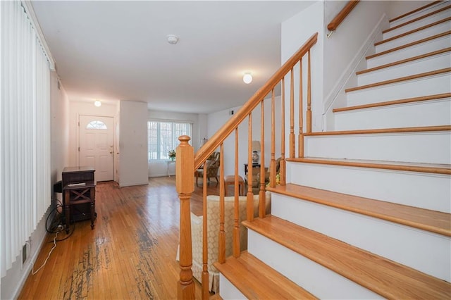 stairs featuring wood-type flooring