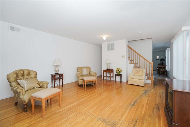 sitting room with wood-type flooring