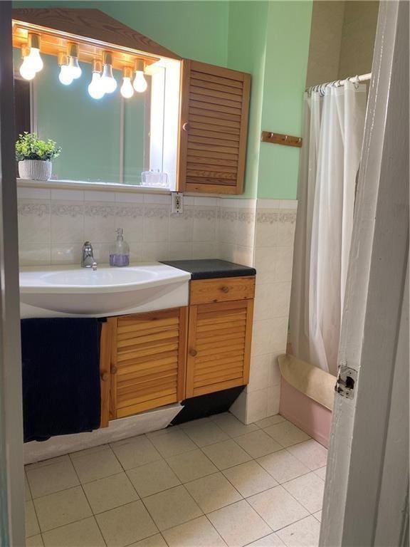 bathroom featuring tasteful backsplash, curtained shower, tile patterned flooring, and vanity