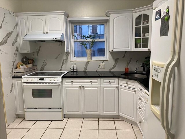 kitchen featuring sink, white cabinets, white appliances, and light tile patterned floors