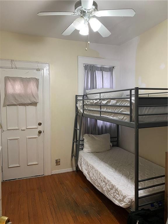 bedroom featuring ceiling fan and dark hardwood / wood-style flooring