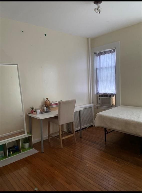 bedroom featuring dark hardwood / wood-style floors and cooling unit