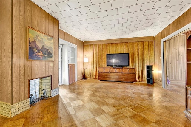 unfurnished living room featuring light parquet flooring and wooden walls