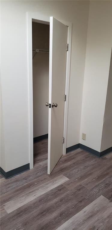 unfurnished bedroom featuring wood-type flooring and a closet