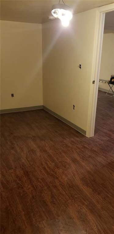 empty room featuring dark hardwood / wood-style flooring