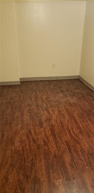 unfurnished room featuring dark hardwood / wood-style flooring