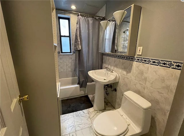 full bathroom featuring shower / tub combo with curtain, toilet, tile walls, and sink