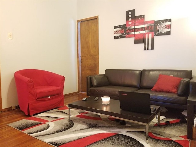 living area with wood finished floors and baseboards