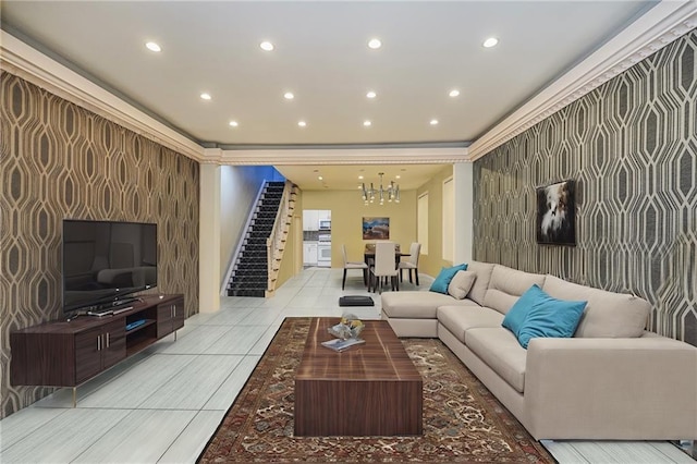 living area featuring an accent wall, recessed lighting, and a chandelier