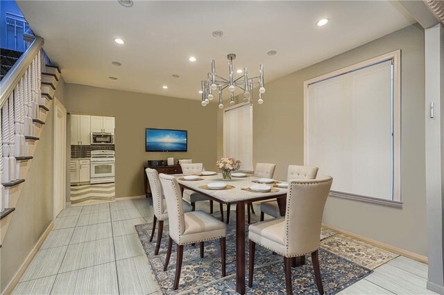 tiled dining room featuring a chandelier