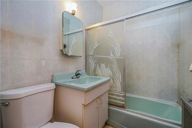 full bathroom with shower / tub combination, vanity, toilet, and tile walls