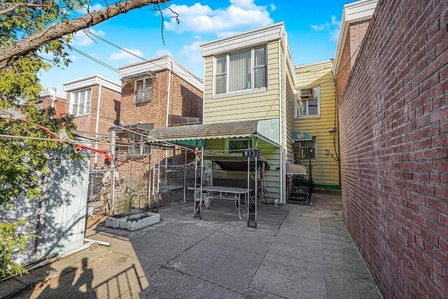 rear view of property featuring a patio area