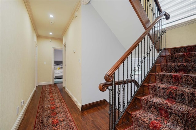 staircase with hardwood / wood-style flooring and ornamental molding