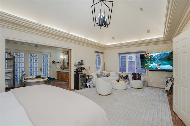 bedroom with french doors, ensuite bathroom, crown molding, a chandelier, and a tray ceiling