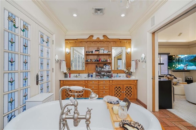 bathroom featuring a tub, crown molding, and vanity