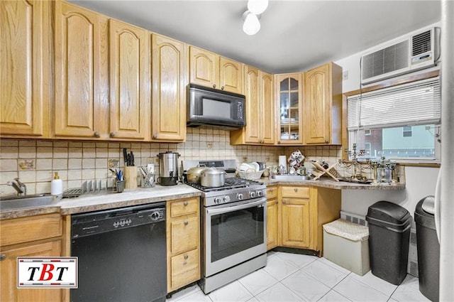 kitchen featuring sink, black appliances, light brown cabinets, and tasteful backsplash