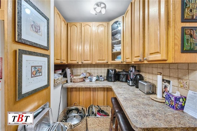 kitchen with tasteful backsplash and light brown cabinets