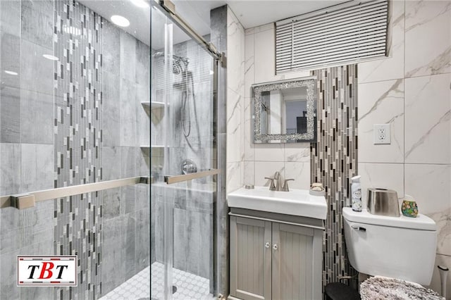 bathroom featuring toilet, walk in shower, tile walls, backsplash, and vanity