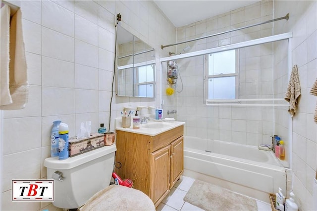 full bathroom with tile patterned flooring, enclosed tub / shower combo, tile walls, tasteful backsplash, and vanity