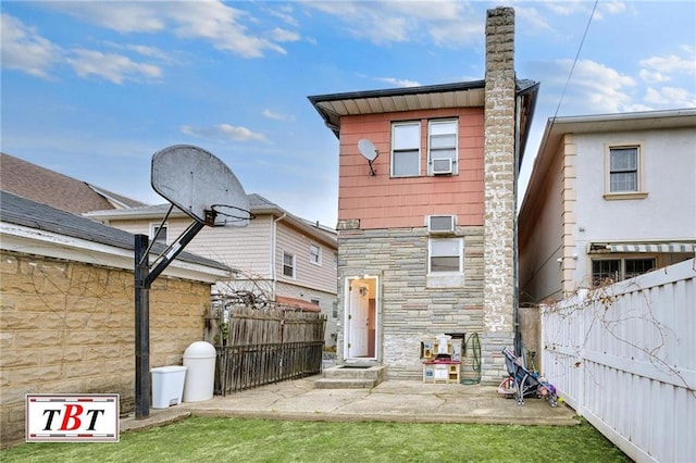 back of house with a patio and a yard