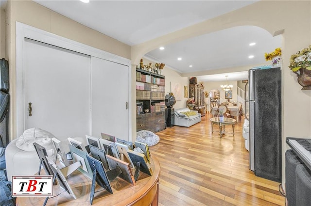 interior space with an inviting chandelier and hardwood / wood-style flooring