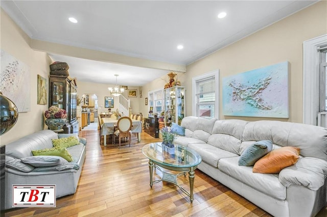 living room with a notable chandelier and light wood-type flooring