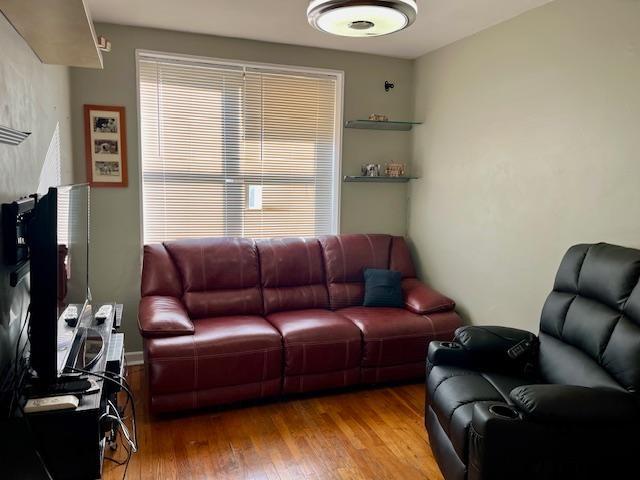 living area with hardwood / wood-style flooring