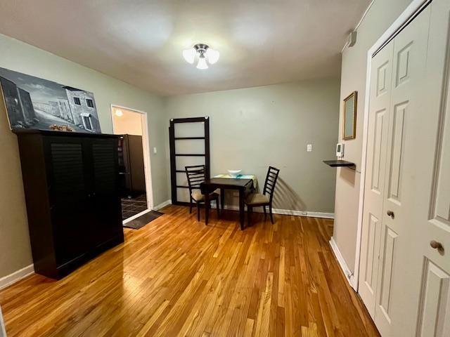 foyer with light wood-style flooring and baseboards