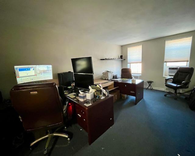 carpeted office featuring baseboards