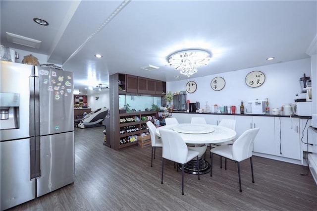 dining area featuring a notable chandelier and dark wood-type flooring