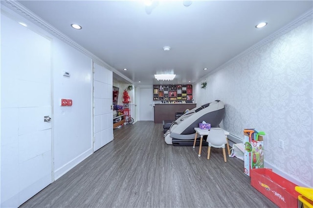 recreation room with crown molding and dark hardwood / wood-style flooring