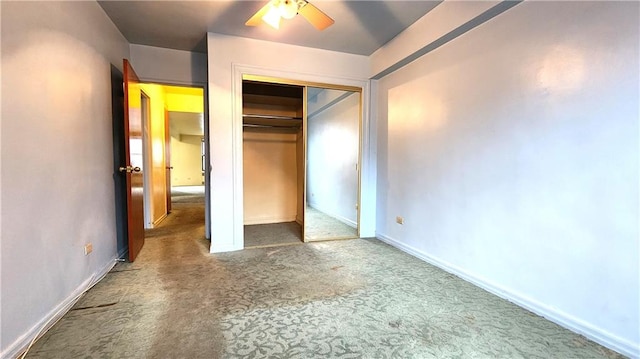 unfurnished bedroom featuring a closet, carpet flooring, ceiling fan, and baseboards