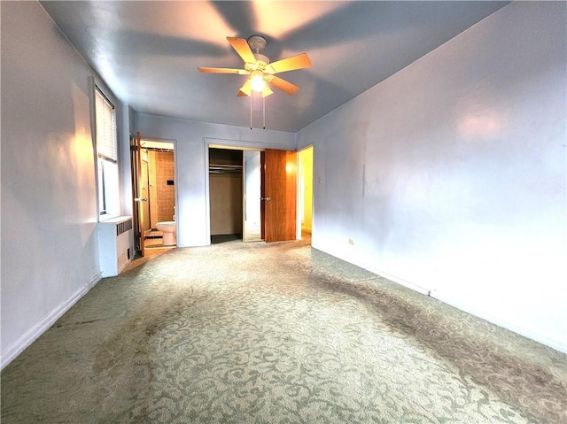 unfurnished bedroom with ceiling fan, connected bathroom, carpet, and a closet