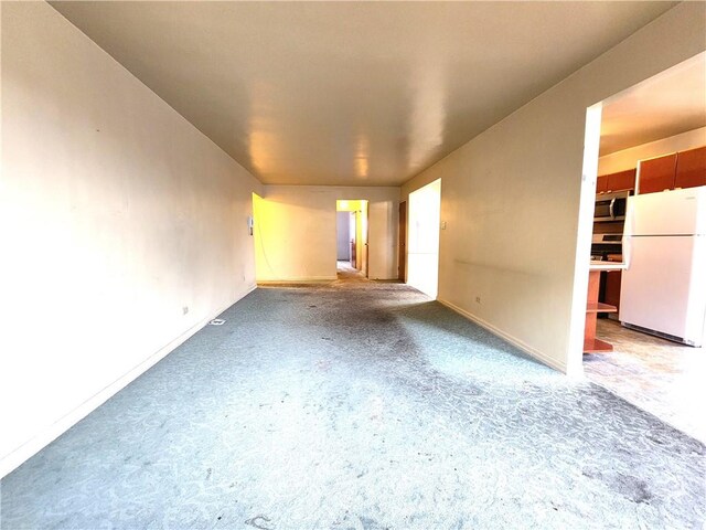 unfurnished living room with concrete floors