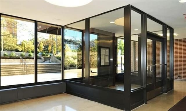 entryway with tile patterned floors and a healthy amount of sunlight