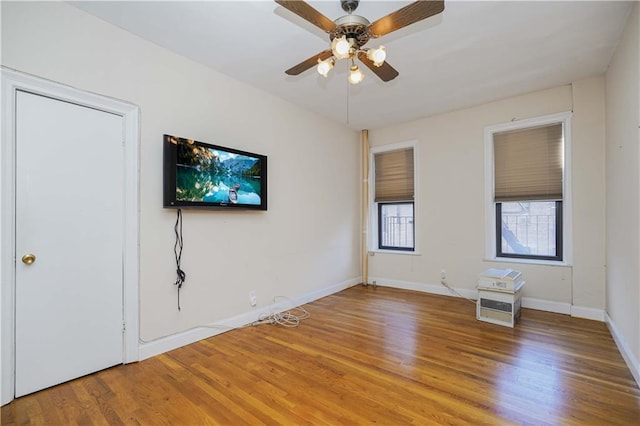 unfurnished room featuring ceiling fan and hardwood / wood-style floors