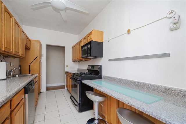 7101 Colonial Rd Unit L5I, Brooklyn, NY 11209 - kitchen featuring appliances with stainless steel finishes, a ceiling fan, light tile patterned floors, a sink, and a kitchen bar