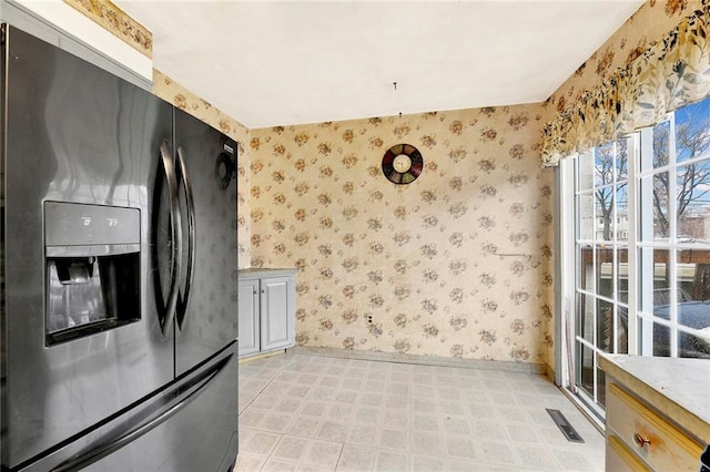 kitchen featuring stainless steel fridge with ice dispenser