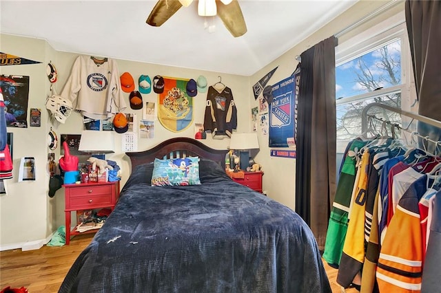 bedroom with ceiling fan and hardwood / wood-style floors