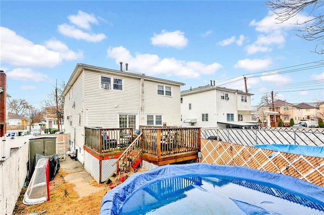 back of house with a pool side deck