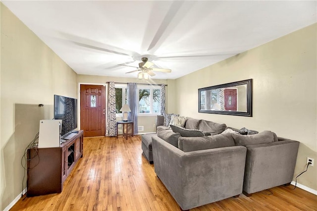 living room featuring ceiling fan and hardwood / wood-style floors