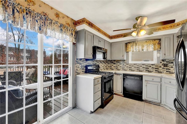 kitchen featuring ceiling fan, black appliances, tasteful backsplash, and gray cabinetry