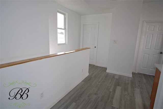 hallway with dark hardwood / wood-style floors